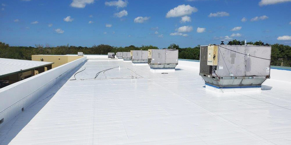 Commercial flat roof with a newly applied silicone roof coating. Seamless, waterproof, and UV-resistant solution for long-term protection and energy efficiency.