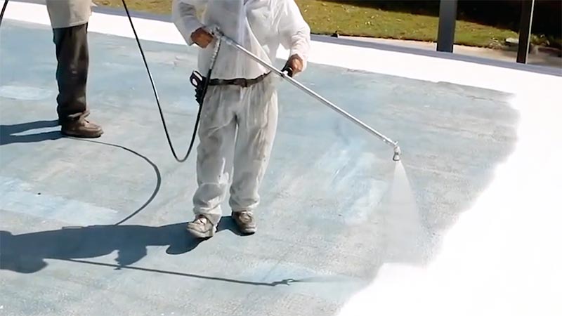 Roofing professionals applying a silicone roof coating using a spray system. Seamless, waterproof protection for commercial and residential flat roofs.